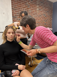 Person applying makeup to a person getting ready for an event - Siba - Stevens Institute of Business Person applying makeup to a person getting ready for an event