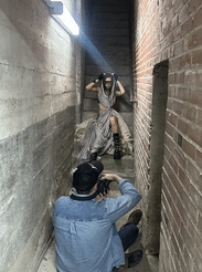 Photo shoot with model up against a brick and concrete wall - Siba - Stevens Institute of Business